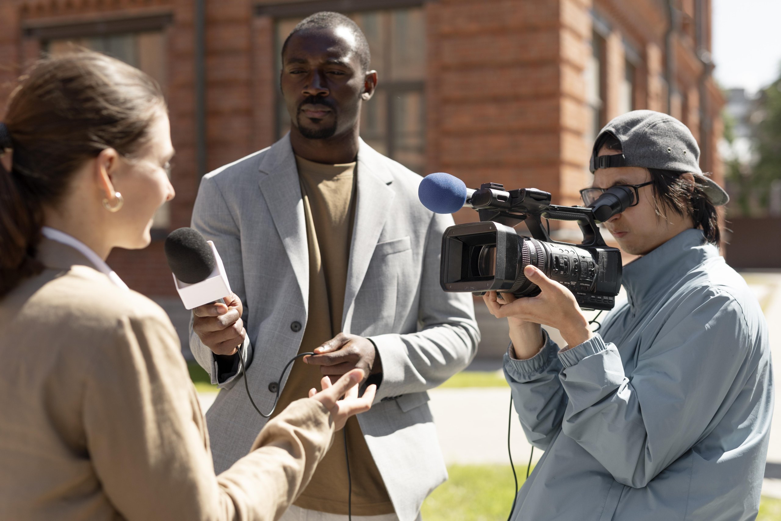 group people taking interview outdoors