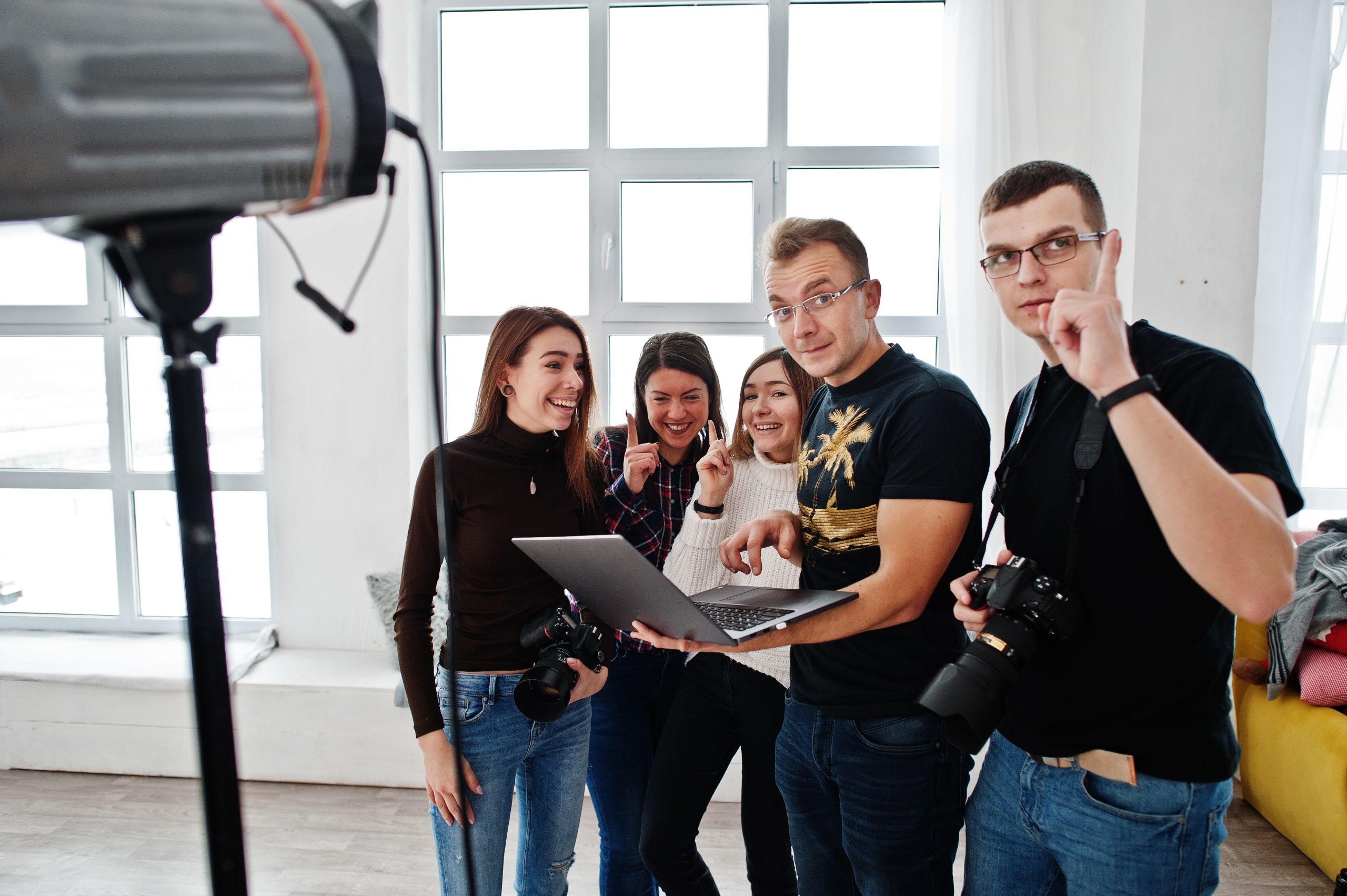 photographer explaining about the shot to his team in the studio